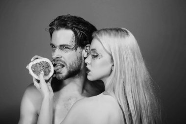 erkek ve kadın makyaj ile greyfurt tutun