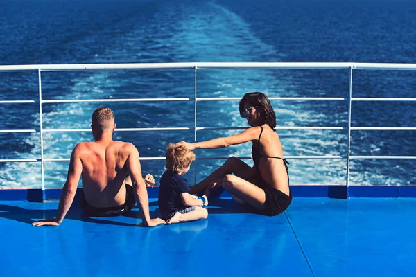 Family travel with kid on mothers or fathers day. Mother and father with son in sea on yacht. Love and trust as family values. Child with father and mother. Summer vacation of happy family.