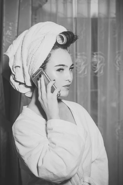 Sexy lady with mysterious face speaks on phone.