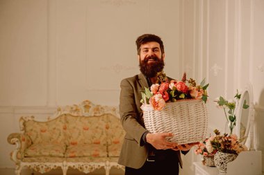 Çiçek kavramı. Adam tutun sepeti taze çiçekler ile sakallı. Çiçekçi adam. Çiçek satışı