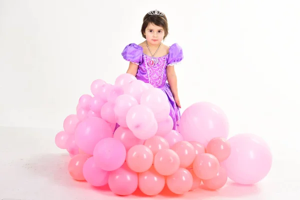 Party balloons. Happy birthday. Little girl in princess dress. Kid fashion. Little miss in beautiful dress. Childhood and happiness. Childrens day. Small pretty child. Enjoying great story