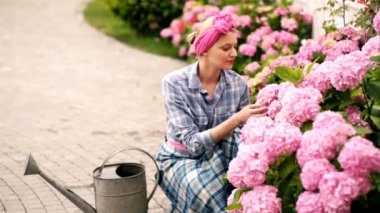 Gardening and people concept. Women care flowers. Beautifull flowers. Beautiful garden flowers. Spring flowers. Home and Garden concept.
