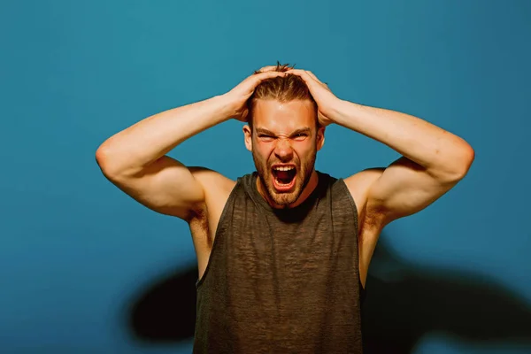 Stress concept. Stressed man pull out hair on head of stress. Handsome man shout with stress. Give your stress wings and let it fly away