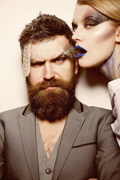 Visage course. Sensual woman and bearded man with creative makeup, visage course. Visage course of professional makeup. Visage course in beauty salon. Find your best look here