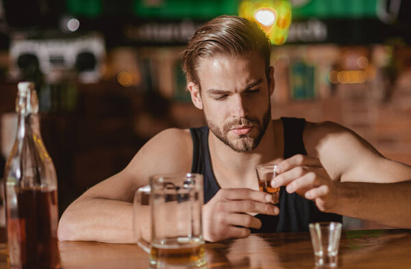 Heavy drinking is bad. Alcoholic man drinking at bar counter. Man drink strong alcoholic beverage and beer in pub. Alcohol addict with short alcohol drink. Alcohol addiction. Drinking alcohol
