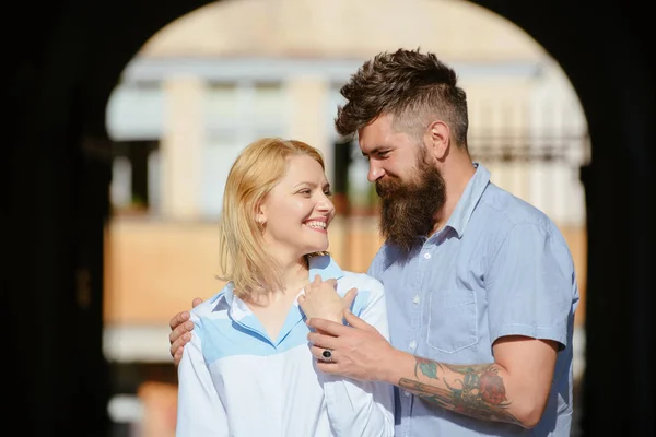 Falling in love with a blonde. Sensual woman and man enjoy romantic date. Couple in love. Loving couple of woman and hipster dating outdoor. Bearded man hug sexy girl. Feeling love and romance