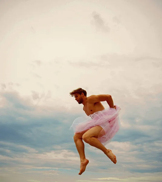 Man dancing in tutu in ballet studio. Crazy ballerina. drag queen. Man in ballerina skirt outdoor. Funny man freak. Inspiration and dreaming. sense of freedom. Man jump on sky background.