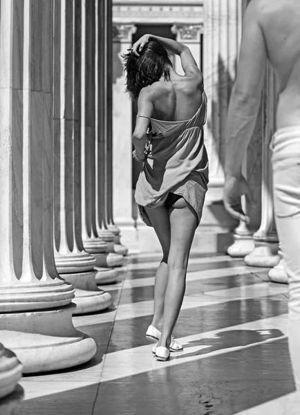 sexy girl and man walk among ancient columns. Love relations of sexy couple at summer day. Summer holidays and travel vacation. Couple in love show summer fashion. Family and valentines day