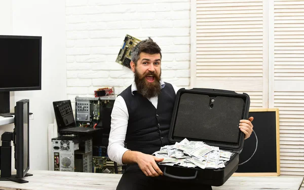 Rich and successful. Bearded man with cash money. Business man with money case in office. Bearded hipster with dollar banknotes. Business and making money. Withdrawing cash from electronic money