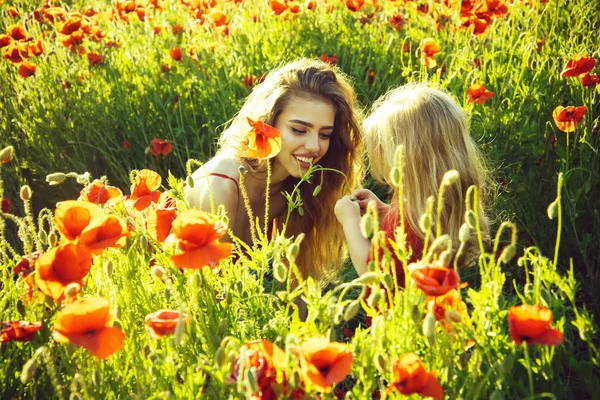 Girl and little boy or child in field of poppy — Stock Photo, Image