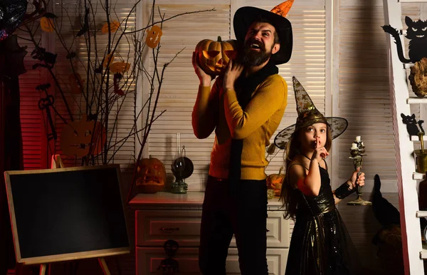 Little girl witch and wizard man enjoy halloween party. Little girl in wizard hat and father in costume party on halloween. Party lika an all star. Lets party on halloween night — Stock Photo, Image