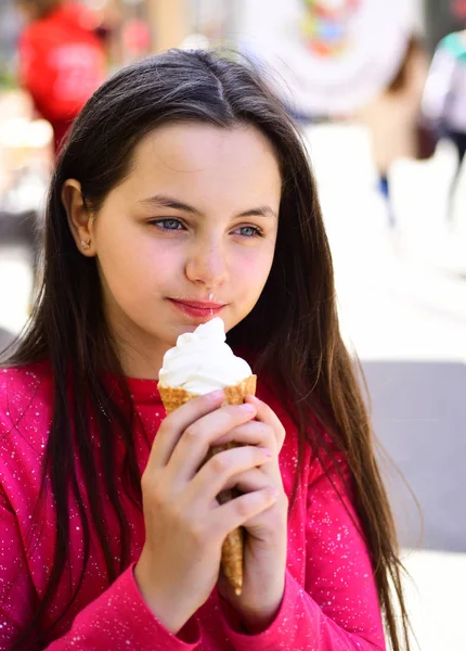 Enjoying frozen food snack or dessert. Happy girl child eating ice cream in hot weather. Cute girl smiling with ice cream. Pretty girl hold ice cream cone on summer day. A wonderful blend of flavor