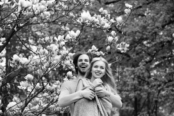 garden with magnolia flower in spring, summer, man and woman