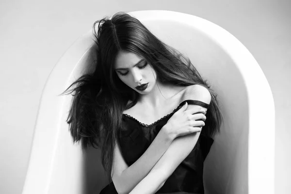 Woman in dress with long hair, black lipstick in bath — Stock Photo, Image