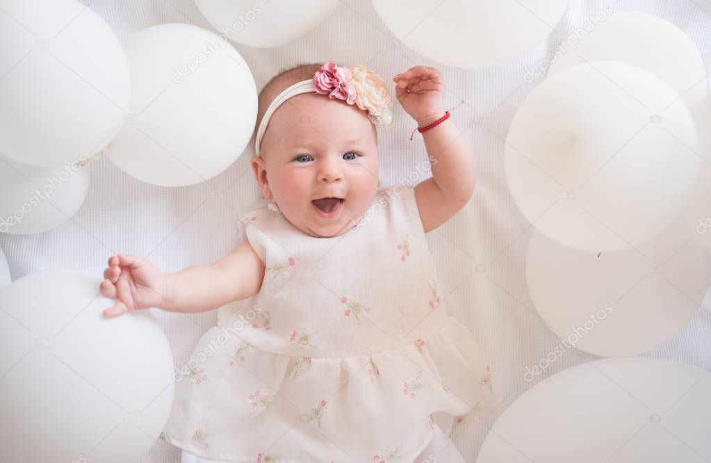 Wow. Family. Child care. Childrens day. Small girl. Happy birthday. Sweet little baby. New life and birth. Portrait of happy little child in white balloons. Childhood happiness