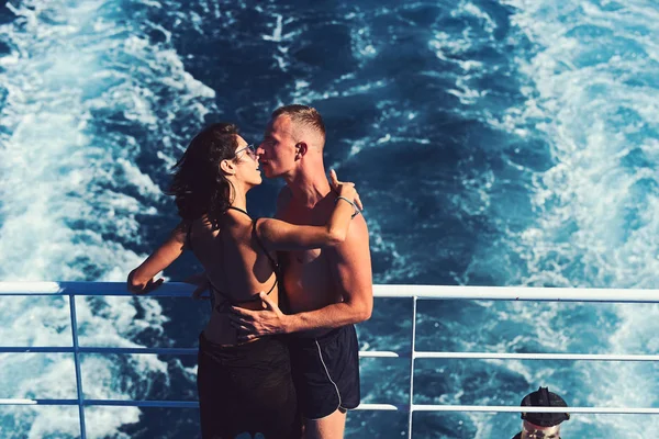 Sexy woman and man on boat in sea water. Family and valentines day. Summer holidays and travel vacation. Love relations of kissing couple at water trail. Couple in love relax on marine trip — Stock Photo, Image