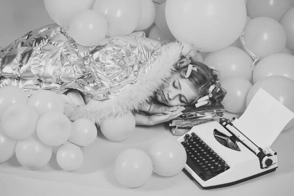 Little Girl in the studio sleep at old typewriter