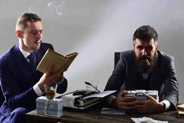 Our business. Money brokers counting profit increase. Successful investment in business. Businessmen write financial report while drinking and smoking. Business partners with cash money