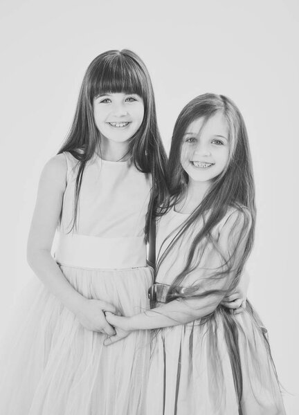 Little girls sister with long hair isolated on white.