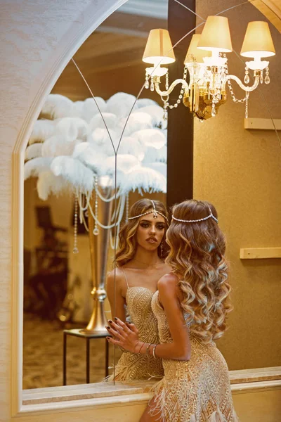 Stylish woman with long curly hair look in mirror. Sexy girl in stylish vintage clothing. Fashion is her life — Stock Photo, Image