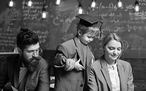 Little child play teacher with woman and man. Genius son teach mother and father students. Family together on chalkboard with bulbs, ideas. Back to school. Future and education concept — Stock Photo, Image