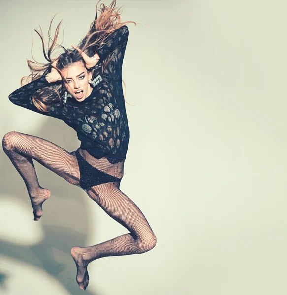 Hoppning vacker ung kvinna med långa blonda hår, med sexiga läppar hoppa i grå studio, kopiera utrymme — Stockfoto