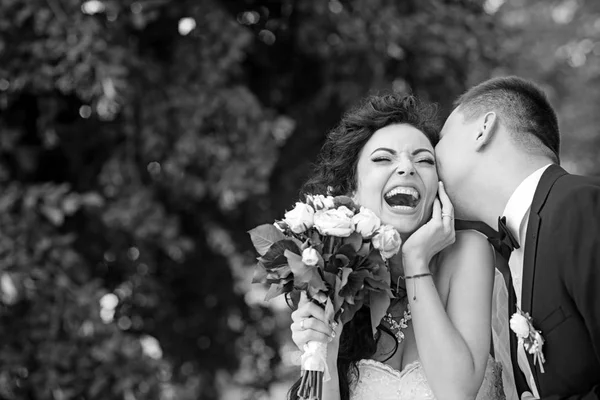 Groom kissing happy bride on wedding day — Stock Photo, Image