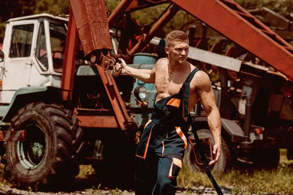Power concept. Power man pull tractor with crane. Power lifter at construction site. Feel the power — Stock Photo, Image