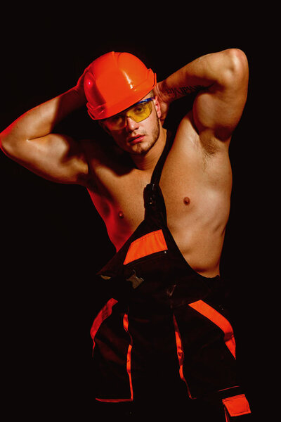 My reputation is built on solid ground. Man worker with muscular sexy body. Handsome worker or workman. Construction worker or builder. Muscular man wear hard hat and uniform. Confident and strong