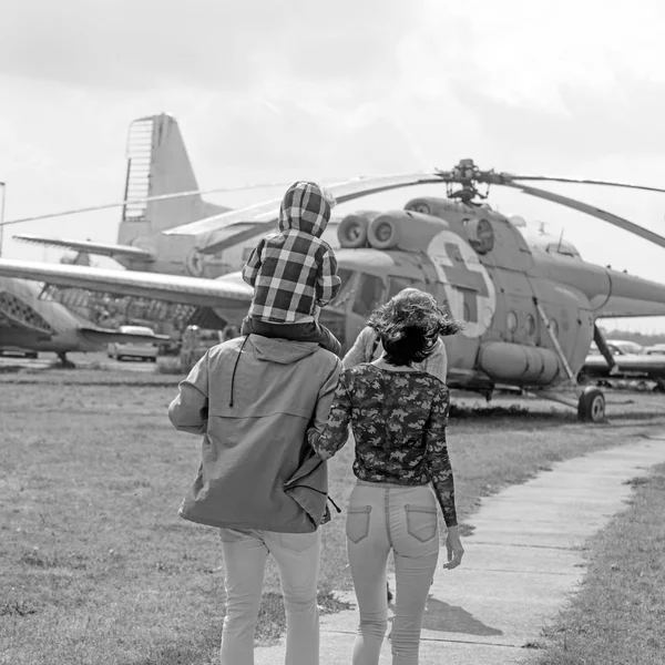 Explore the world. Family vacation. Family couple with boy child on vacation trip. Mother and father with son at helicopter. Helicopter tour and travel. Air travel. Enjoying travelling by air
