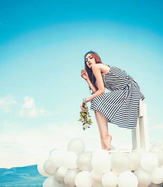 Woman in summer dress with party balloons. inspiration and imagination. girl with flowers sit in sky. feeling freedom and dreaming. Fashion portrait of woman. Sexy beauty — Stock Photo, Image