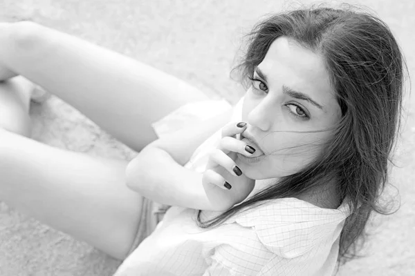 Woman on calm face with make up, floor on background, defocused. Girl with long hair looking at camera while licking her fingers. Lady looks sensual and tender, close up. Sensuality concept. — Stock Photo, Image