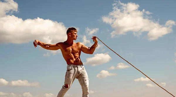 Big result requires big ambition. Sport exercises to build strength and power. Strong man pull rope. Sport man develop muscular hand strength. Athlete with fit sexy torso. Achieving ambition in sport