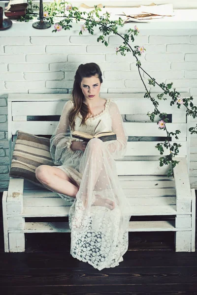 Frühjahrs- oder Sommermädchen entspannen auf Bank. Mode Frau Modell lesen Buch. Schönheit und Mode im Vintage-Stil. Gedichtband beim romantischen Schriftsteller. hübsches Mädchen in weißem Hochzeitskleid und Retro-Frisur — Stockfoto