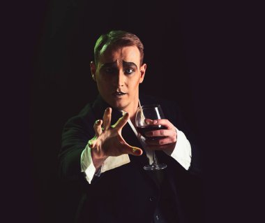 Bekle. MIME sanatçı sahnede gerçekleştirin. Sahne aktör pandomim şarap içme. Komedyen MIME makyaj ile şarap kadehi tutun. Dram Tiyatrosu aktör miming. Tiyatro performans sanatı ve reis komedi. MIME adam
