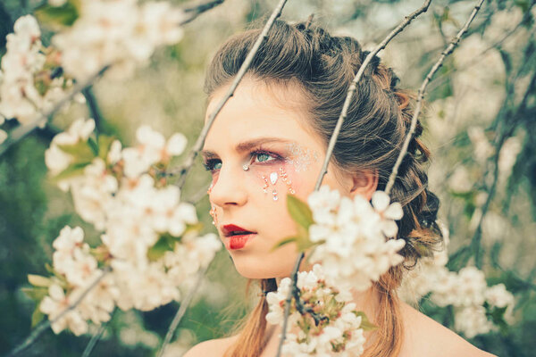 Hot day. Summer girl at blooming tree. face and skincare. womens health. allergy to flowers. Natural beauty and spa therapy. Springtime vacation. weather forecast. Woman with spring fashion makeup.