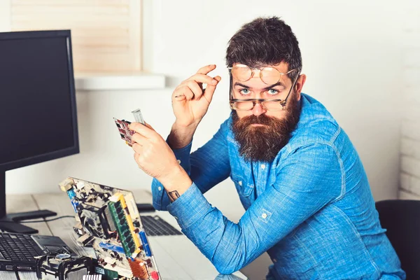 Working with passion. Assemblying of electronic devices. Bearded man repair circuit board. Engineer or technician at work. Bearded hipster works on fixing digital hardware. New technology and tech