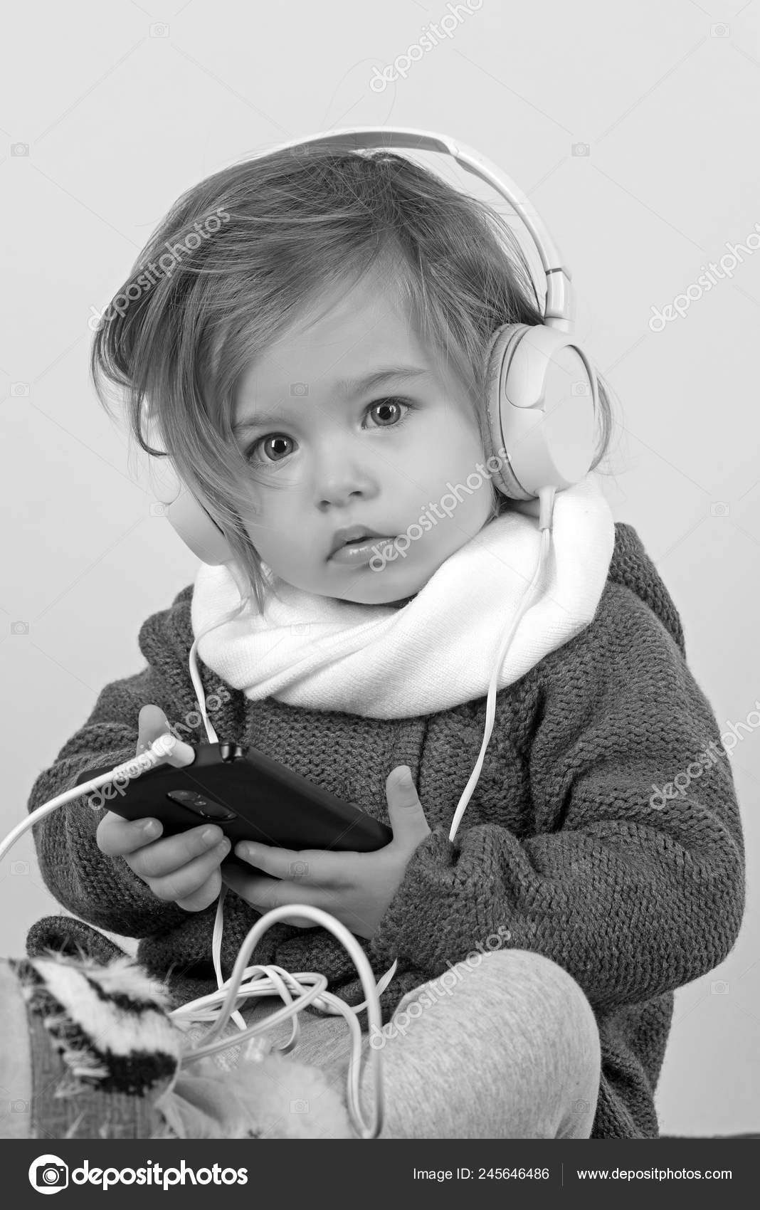 Kid listen music with headset and mp3 on having winter