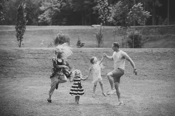 Meninas, mulher e homem sorriem na paisagem de verão — Fotografia de Stock