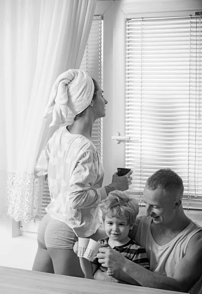 Mother and father with son after shower. Perfect morning of happy family drinking coffee. Love and trust as family values. Parents with kid on mothers or fathers day. Child with father and mother — Stock Photo, Image