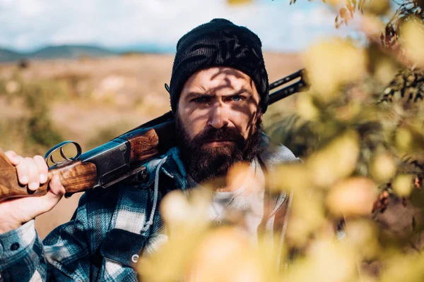 Chasseur avec fusil de chasse en chasse. Homme tenant un fusil de chasse . — Photo