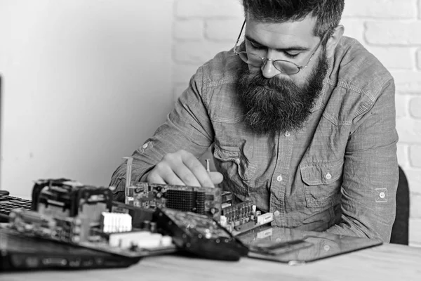 Smart professional. Bearded man repair circuit board. Engineer or technician at work. Bearded hipster works on fixing digital hardware. Assemblying of electronic devices. New technology and science