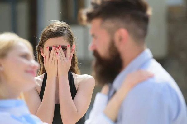 Possessive and jealous. Romantic couple of man and woman dating. Jealous girl look at couple in love on street. Bearded man cheating his woman with another girlfriend. Unhappy woman feeling jealous — Stock Photo, Image