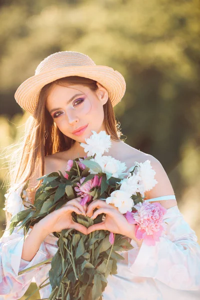 flower shop. Natural beauty and spa therapy. Spring woman. Springtime and vacation. Summer girl with long hair. Woman with fashion makeup. face and skincare. Travel in summer