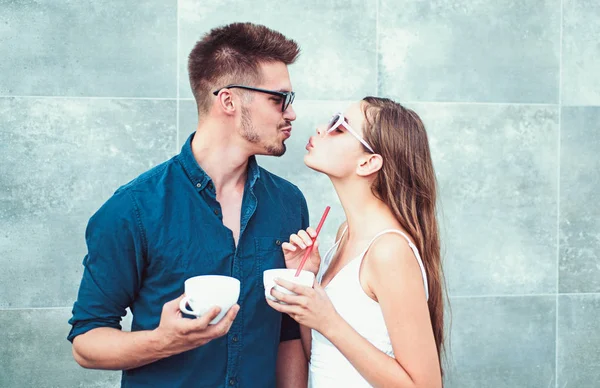 Nothing but very two hot beverages between you. Woman and man have latter drink. Couple in love drink coffee outdoor. Couple of woman and man with coffee cups. Enjoying the best coffee date