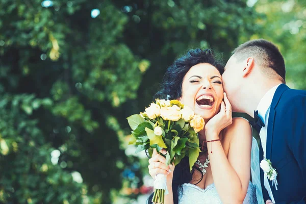 Groom kissing happy bride on wedding day — Stock Photo, Image