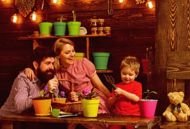 Bahçe kavramı. Küçük çocuk annesi ve babası yeni tencerede Bahçe çiçek Çömlekçilik yardımcı olur. Ev Bahçe. Bahçeme için çalışmayı çok