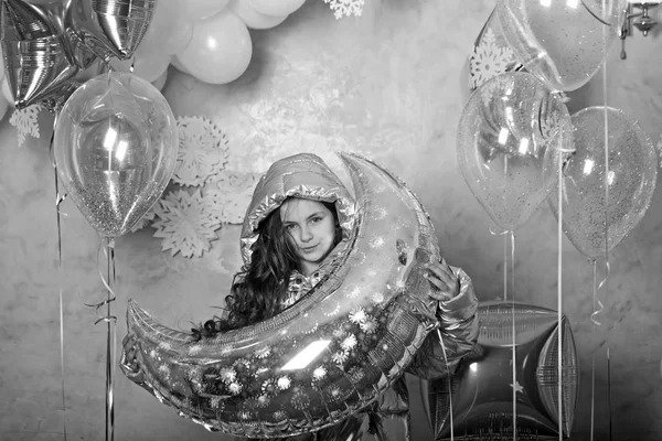 Girl with silver crescent moon balloon, ramadan. Small child in winter jacket with party balloons. Party decor and design for holidays celebration. Christams new year or ramadan concept — Stock Photo, Image