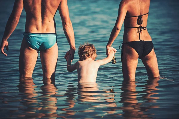 Familia feliz en el mar divirtiéndose en el agua, madre y padre con el niño disfrutando del resort de playa en vacaciones de verano, concepto de vacaciones . —  Fotos de Stock