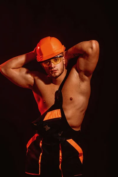 Pride in all I do. Confident and strong. Man worker with muscular sexy body. Construction worker or builder. Handsome worker or workman. Muscular man wear hard hat and uniform